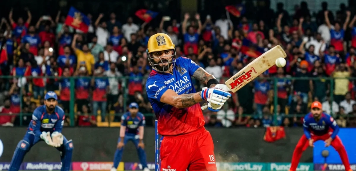 Virat Kohli batting during an IPL match, focusing intently on the ball.